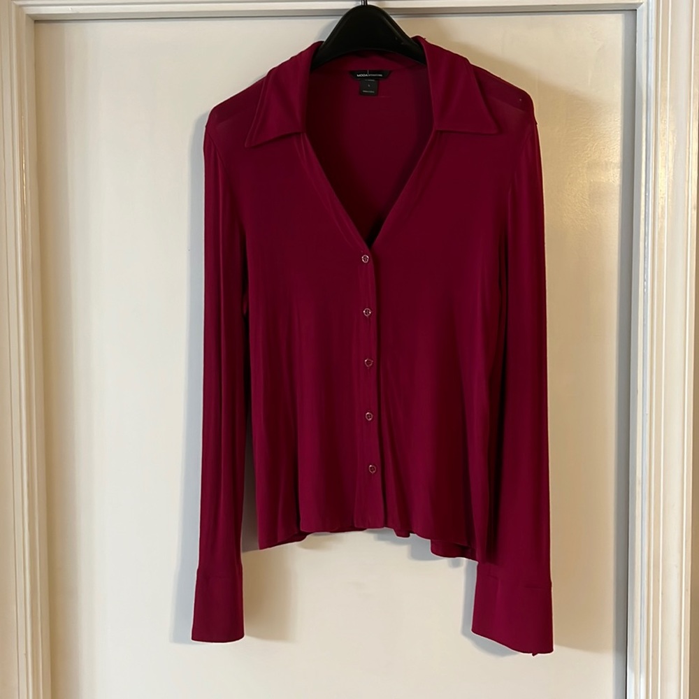 Pomegranate V neck button down long sleeve 90% rayon 4% spandex for elasticity.